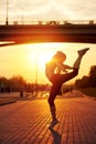 modern style dancer woman jumping. Dancer silhouette at sunset. Contour of girl on urban city background Royalty Free Stock Photo