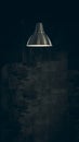 Modern style decoration metal lamps and lampshades hanging against dark wall.Vintage Metallic stylish hang ceiling cone lamp Royalty Free Stock Photo