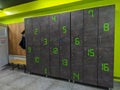 Modern style locker room or dressing room with numbers on lockers in grey and green colors used for changing clothes and safety