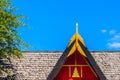 Modern style of the roof gable end with the red and gold decoration under blue sky background. Royalty Free Stock Photo