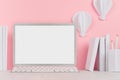 Modern style workplace - white stationery, blank notebook computer and decorative paper balloons on soft pink background and light Royalty Free Stock Photo