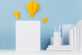Modern style workplace - white stationery, letterhead and decorative yellow paper lightbulbs on soft blue background. Royalty Free Stock Photo