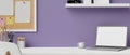Modern stylish creative workspace with laptop mockup over purple wall background Royalty Free Stock Photo