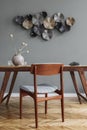 Stylish dining room with wooden table and vintage chair.