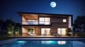 Modern stylish home with large windows and a swimming pool in the foreground at night in the moonlight. Modern Royalty Free Stock Photo