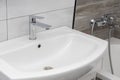 Modern and stylish interior of the bathroom in the apartment, close-up of the washbasin. Royalty Free Stock Photo