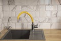 Modern and stylish kitchen with calacatta stone metro tile and grey granite faucet and yellow basin mixer