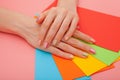 Modern stylish manicure rainbow or summer mood, on a pink table with color envelopes. Close-up