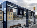 Modern suburban public bus stop constructed mainly using glass panels
