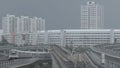 Modern subway train on a railroad in Sinapore on a city buildings background. Shot. Singapore mass rapid train MRT