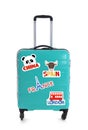 Modern suitcase with travel stickers on background