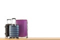 Modern suitcases baggage for travelling or business trip on wooden floor against white isolated background