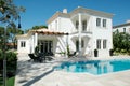 Modern Summer Mansion with Patio and Blue Pool Royalty Free Stock Photo