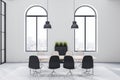 Modern sunny meeting room with city view from arched windows, light wooden conference table and black and white chairs around on