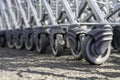Modern supermarket shopping cart wheels in a row. Many rubber wheels of shopping trolleys Royalty Free Stock Photo