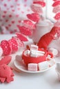 Modern surreal tea party with living coral color toy, sweetness, wonderland morning on windowsiil, unusual still life background