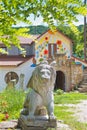 Modern symbolic sculpture of winged Lion of evangelist Saint Mark, carved in stone on pedestal, modern souvenir shop