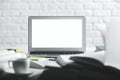 Modern table with empty white laptop screen Royalty Free Stock Photo