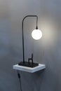 Modern table lamp, black night lamp in the form of a ball hanging over a chair. Small original floor lamp