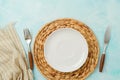 Modern table setting with empty plate, tablecloth and silverware. Mock up background for display. Top view, flat lay Royalty Free Stock Photo