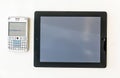 Modern Tablet and old QWERTY smartphone above the Financial Time