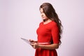 Modern tablet. Young girl. Red dress Royalty Free Stock Photo
