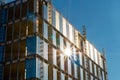 Modern tall building construction site. Metal frame and a lot of glass. Blue cloudy sky. Building new residential and office space Royalty Free Stock Photo