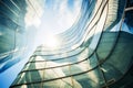 Modern tall building with futuristic design, abstract curve shapes, glass, sun and sky. Low angle of city towers, wavy geometric