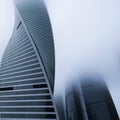 Modern tall skyscraper in dense fog, closeup. Square cropping