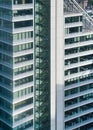 Modern tall steel and glass office building, closeup detail to regular windows, staircase visible Royalty Free Stock Photo