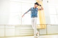 Modern tattooed art dancer teenager dressed in jeans vest, white pants and black hat dancing and mirror posing portrait