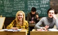 Modern teacher hipster writing on big blackboard with math formula. Be cool and you will be able to attract and retain