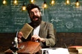Modern teacher hipster writing on big blackboard with math formula, E-Learning concept with student holding his modern Royalty Free Stock Photo