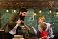 Modern teacher hipster writing on big blackboard with math formula, Teacher respects students, Professor and school