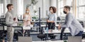 Modern team meeting, group work and social distancing. Manager with tablet speaks with workers in protective masks in Royalty Free Stock Photo