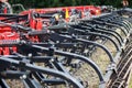 Modern tech red tractor plowing a green agricultural field in spring on the farm. Harvester sowing wheat. Royalty Free Stock Photo