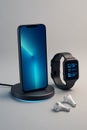 Modern Tech Setup with Smartphone, Smartwatch, and Wireless Earbuds Royalty Free Stock Photo