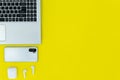 Modern Tech Workspace With Laptop, Smartphone, AirPods And Plant On Bright Yellow Background.Ideal for tech, work, and lifestyle t Royalty Free Stock Photo