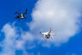 Modern technological shipment innovation. Drone fast delivery concept, two multicopters flying in the sky. Royalty Free Stock Photo