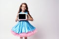 Modern technologies. Beautiful little girl. Lush blue dress