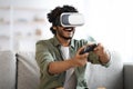 Young man trying virtual reality, playing video games Royalty Free Stock Photo