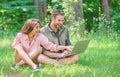 Modern technologies give opportunity to be online and work in any environment conditions. Man and girl looking at laptop