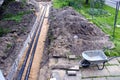 Modern technology black heating pipes in trench and used barrow