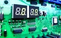 Modern technology, electronic parts, microcircuits, diodes, capacitors and display, on a green circuit board Royalty Free Stock Photo