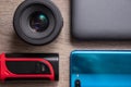 Modern technology flat lay, laptop, camera lens, vaping device and blue smartphone