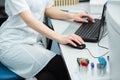 Modern technology in science. Scientist entering data of analysis or research results to laptop at laboratory.