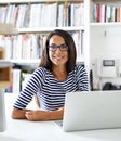 Modern technology for a techno-savvy woman. an attractive young woman surfing the net from her home study.