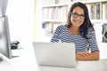 Modern technology for a techno-savvy woman. an attractive young woman surfing the net from her home study.