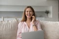 Beautiful woman resting on sofa with laptop look at camera Royalty Free Stock Photo