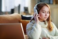 Modern teen girl listening to music while and laptop Royalty Free Stock Photo